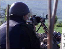 Utanian machine gunner fires on paramilitaries